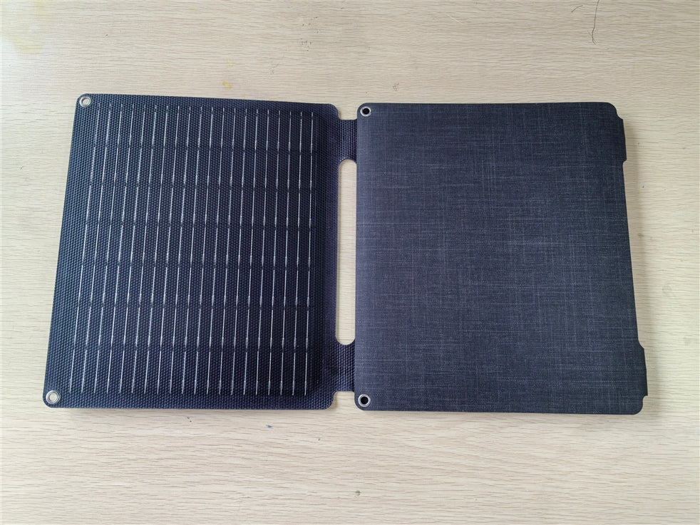 Foldable solar panel on a wooden surface